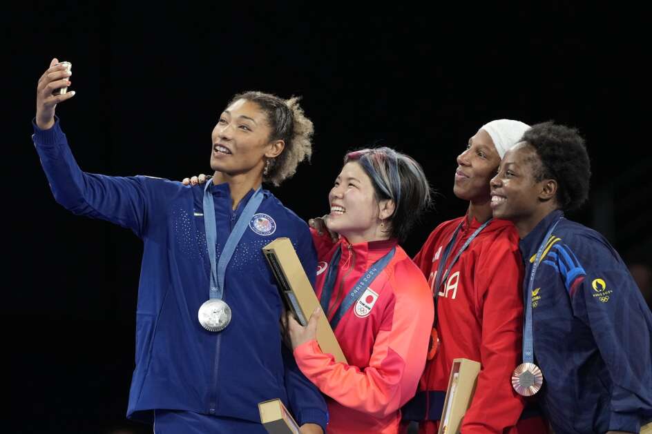 Medalists, from left, Kennedy Alexis Blades, of the United States, silver, Japan's Yuka Kagami, gold, Cuba's De La Caridad Marin Potrille, Colombia's Tatiana Renteria Renteria, bronze, take selfie on the podium during the medal ceremony for women's freestyle 76kg wrestling, at Champ-de-Mars Arena, during the 2024 Summer Olympics, Sunday, Aug. 11, 2024, in Paris, France. (AP Photo/Eugene Hoshiko)