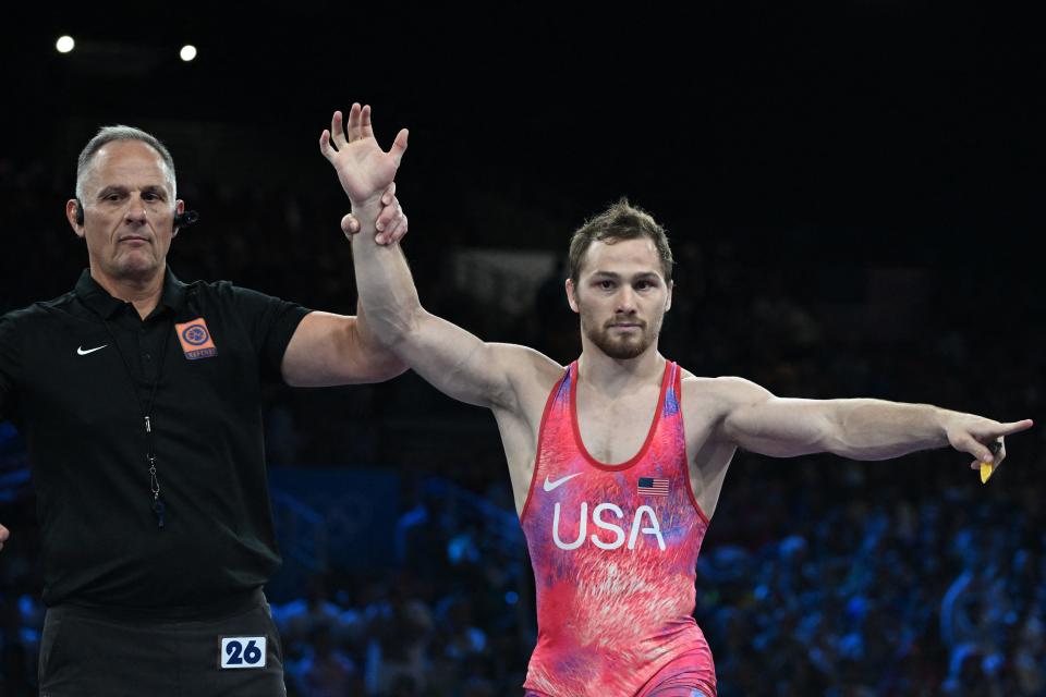 US' Spencer Richard Lee is announced the winner over Uzbekistan's Gulomjon Abdullaev in their men's freestyle 57kg wrestling semi-final match at the Champ-de-Mars Arena during the Paris 2024 Olympic Games, in Paris on August 8, 2024. (Photo by Punit PARANJPE / AFP) (Photo by PUNIT PARANJPE/AFP via Getty Images)