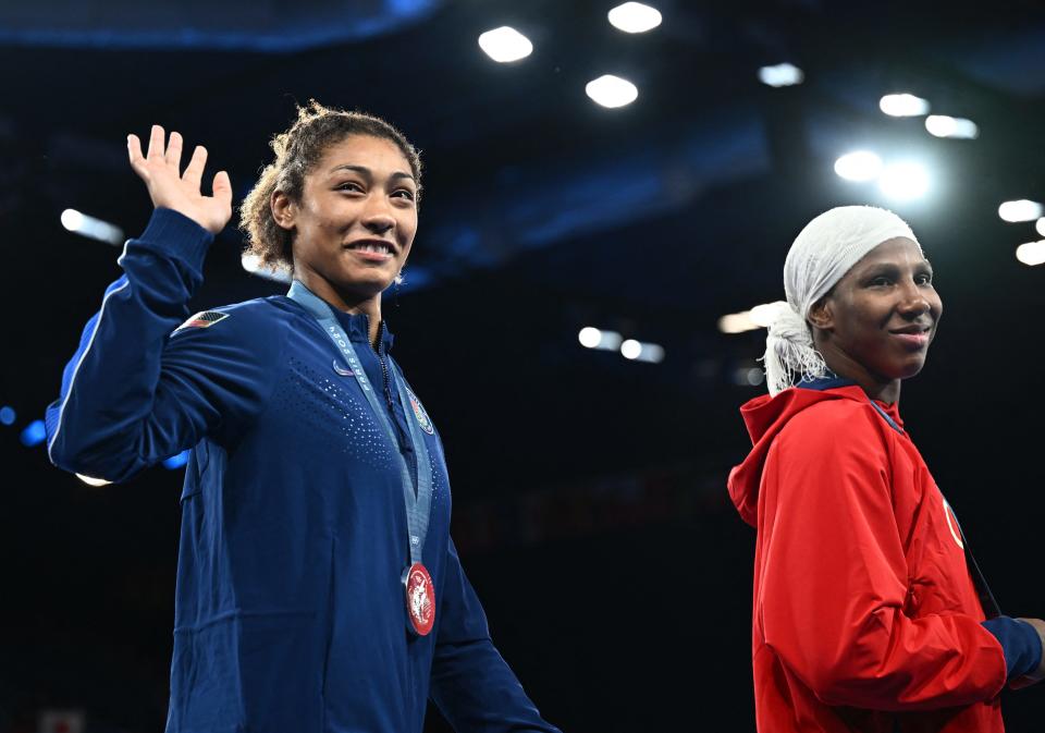 Paris 2024 Olympics - Wrestling - Women's Freestyle 76kg Victory Ceremony - Champ-de-Mars Arena, Paris, France - August 11, 2024. Silver medallist Kennedy Alexis Blades of United States and bronze medallist Milaimy de la Caridad Marin Potrille of Cuba react during the ceremony. REUTERS/Arlette Bashizi