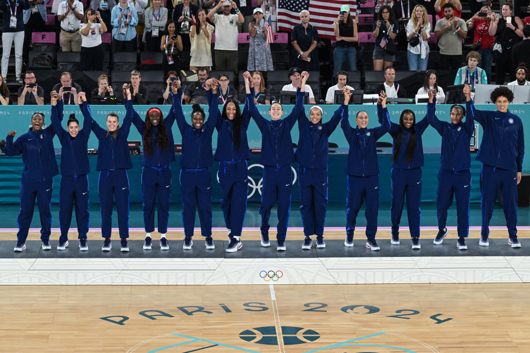 Gold medallists USA stand on the podium after the women's Gold Medal basketball match between France and the USA during the Paris 2024 Olympic Games at the Bercy  Arena in Paris on August 11, 2024. (Photo by Damien MEYER / AFP) (Photo by DAMIEN MEYER/AFP via Getty Images)