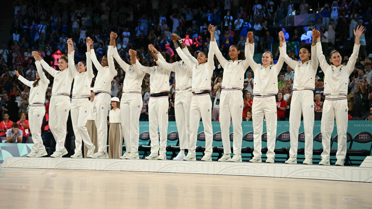 Silver medallists France celebrate on the podium after the women's Gold Medal basketball match between France and the USA during the Paris 2024 Olympic Games at the Bercy  Arena in Paris on August 11, 2024. (Photo by Paul ELLIS / AFP) (Photo by PAUL ELLIS/AFP via Getty Images)