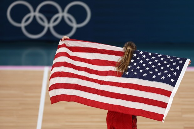 Sabrina Ionescu #6 of Team United States celebrates with the American after her team's victory against Team France during the Women's Gold Medal game between Team France and Team United States on day sixteen of the Olympic Games Paris 2024 at Bercy Arena on August 11, 2024 in Paris, France. (Photo by Sarah Stier/Getty Images)