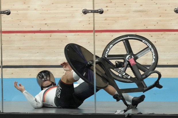 Luca Spiegel of Germany crashes during the men's keirin event, at the Summer Olympics, Sunday, Aug. 11, 2024, in Paris, France. (AP Photo/Thibault Camus)