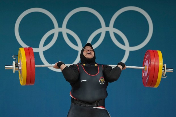 Nurul Akmal of Indonesia competes during the women's +81kg weightlifting event at the 2024 Summer Olympics, Sunday, Aug. 11, 2024, in Paris, France. (AP Photo/Kin Cheung)