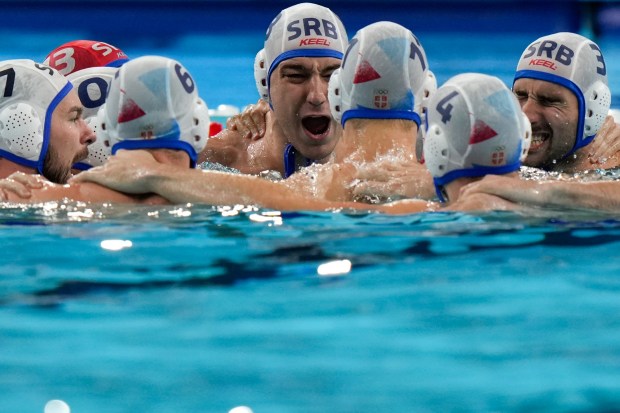 Serbia's players get prepared for the men's water polo gold medal match between Serbia and Croatia, at the 2024 Summer Olympics, Sunday, Aug. 11, 2024, in Paris, France. (AP Photo/Luca Bruno)