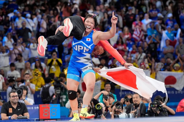 Japan's Yuka Kagami celebrates after defeating Kennedy Alexis Blades, of the United States, in their women's freestyle 76kg final wrestling match, at Champ-de-Mars Arena, during the 2024 Summer Olympics, Sunday, Aug. 11, 2024, in Paris, France. (AP Photo/Eugene Hoshiko)