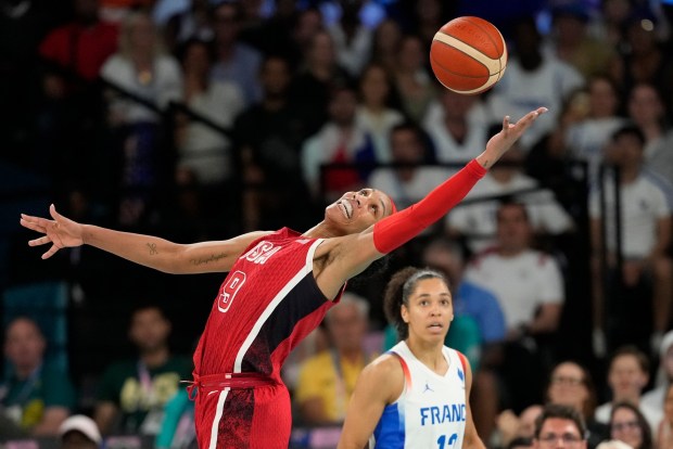 United States' A'ja Wilson (9) grabs a loose ball in front of Janelle Salaun (13), of France, during a women's gold medal basketball game at Bercy Arena at the 2024 Summer Olympics, Sunday, Aug. 11, 2024, in Paris, France. (AP Photo/Michael Conroy)