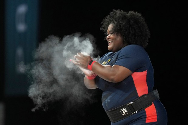 Lisseth Betzaida Ayovi Cabezas of Ecuador reacts during the women's +81kg weightlifting event at the 2024 Summer Olympics, Sunday, Aug. 11, 2024, in Paris, France. (AP Photo/Kin Cheung)