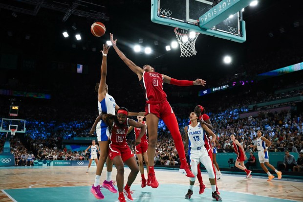 France's #12 Iliana Rupert (L) and USA's #09 A'ja Wilson go for a rebound in the women's Gold Medal basketball match between France and the USA during the Paris 2024 Olympic Games at the Bercy Arena in Paris on August 11, 2024. (Photo by Paul ELLIS / AFP) (Photo by PAUL ELLIS/AFP via Getty Images)