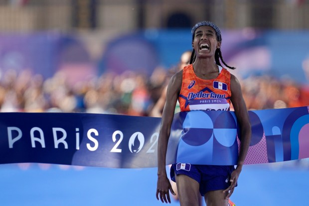 Sifan Hassan, of the Netherlands, celebrates after crossing the finish line to win the gold medal at the end of the women's marathon competition at the 2024 Summer Olympics, Sunday, Aug. 11, 2024, in Paris, France. (AP Photo/Vadim Ghirda)