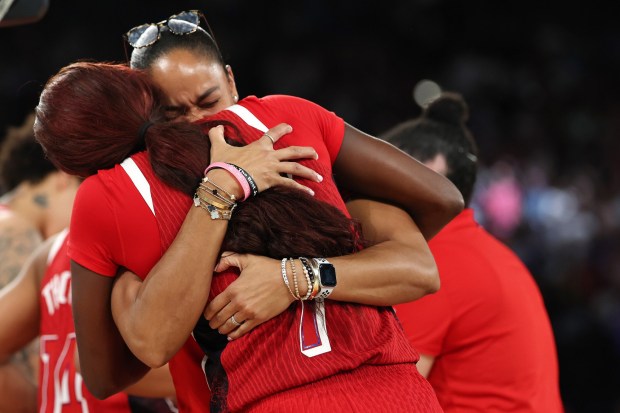 Assistant coach Joni Taylor of Team United States hugs Kahleah Copper #7 of Team United States after their team's win against Team France during the Women's Gold Medal game between Team France and Team United States on day sixteen of the Olympic Games Paris 2024 at Bercy Arena on August 11, 2024 in Paris, France. (Photo by Gregory Shamus/Getty Images)