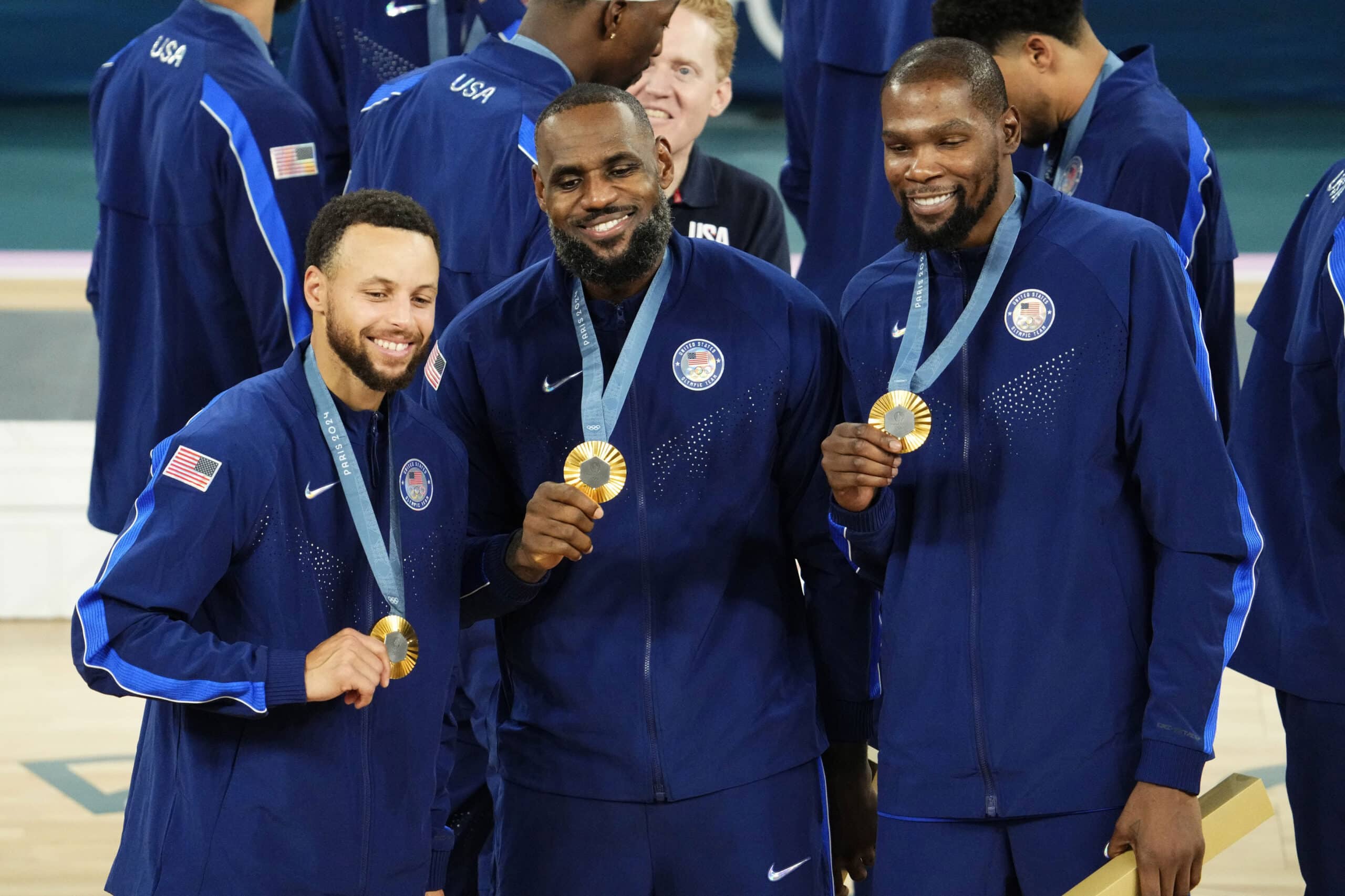 Stephen Curry (4) and guard LeBron James (6) and guard Kevin Durant (7) celebrate with their gold medals