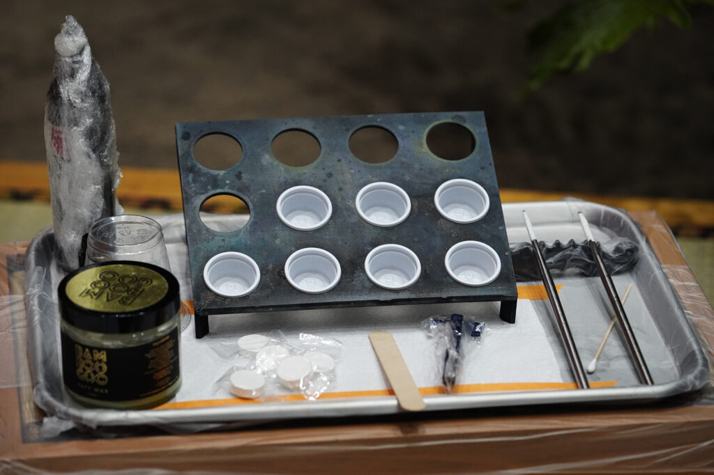 The tray of the tools Tatsutoshi uses is photographed at The Hawaii Tattoo Expo Friday, Aug. 2, 2024, in Honolulu. Tatsutoshi whose name is Ryoma Uno, uses a traditional Japanese style form of tattooing done by hand. (Kevin Fujii/Civil Beat/2024)