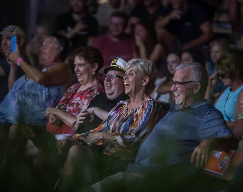 Audience members laugh at a hypnotist performing at a past Wilson County - Tennessee State Fair in Lebanon.