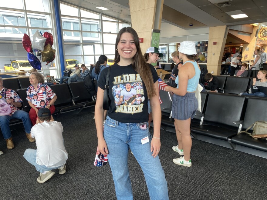 Ilona's sister and manager, Olivia Maher, wears a shirt she designed in the airport terminal 