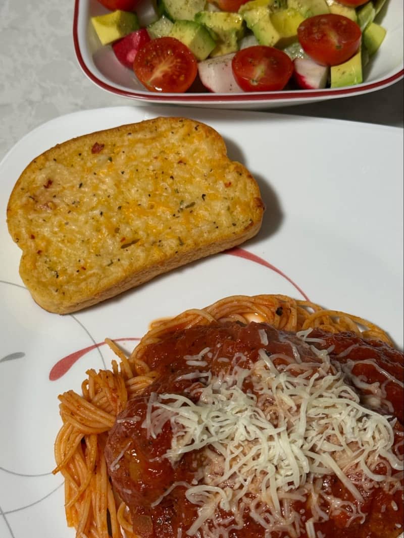 Italian spaghetti and meatballs with garlic bread and salad