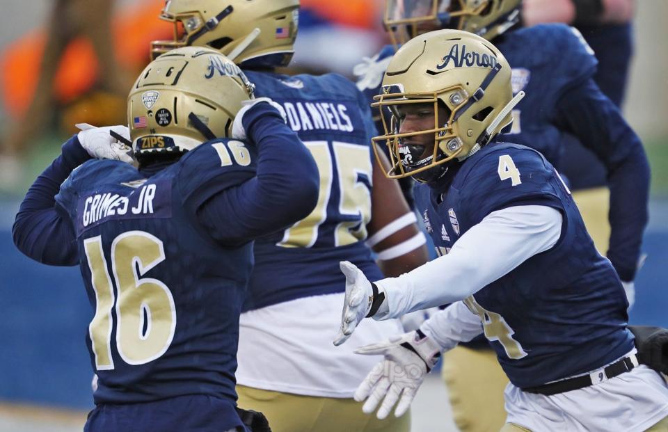 Akron Zips wide receiver George Qualls Jr. (4) celebrates with Akron Zips wide receiver Tony Grimes Jr. (16) after scoring during the first half of an NCAA football game at InfoCision Stadium, Saturday, Dec. 5, 2020, in Akron, Ohio. [Jeff Lange/Beacon Journal]

Zipsfb 1