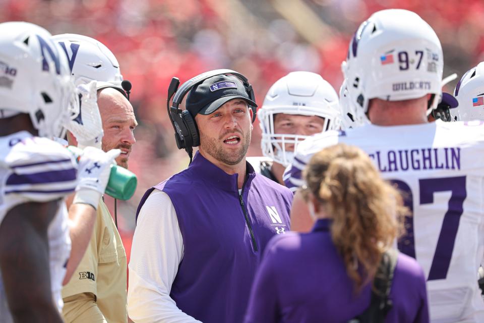 Sep 3, 2023; Piscataway, New Jersey, USA; Northwestern Wildcats interim coach David Braun talks with defensive lineman Sean McLaughlin (97) during the first half against the Rutgers Scarlet Knights at SHI Stadium. Mandatory Credit: Vincent Carchietta-USA TODAY Sports