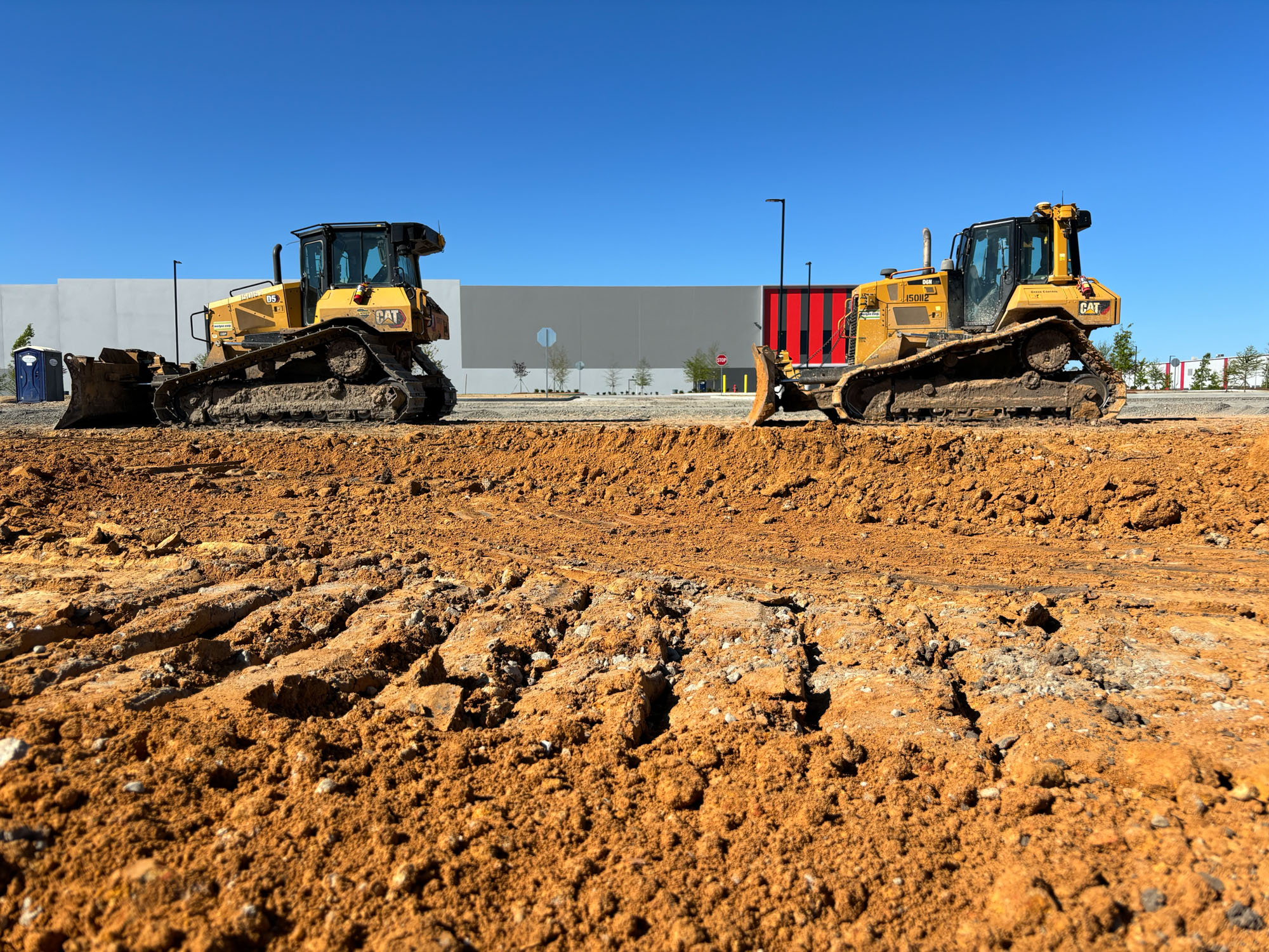 Earthmovers stand outside a freshly erected warehouse near the Hyundai Metaplant.(David Ferris/POLITICO)