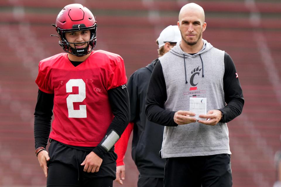 Cincinnati Bearcats quarterback Brendan Sorsby (2), left, smiles during spring football practice, Monday, March 4, 2024, at Nippert Stadium in Cincinnati.