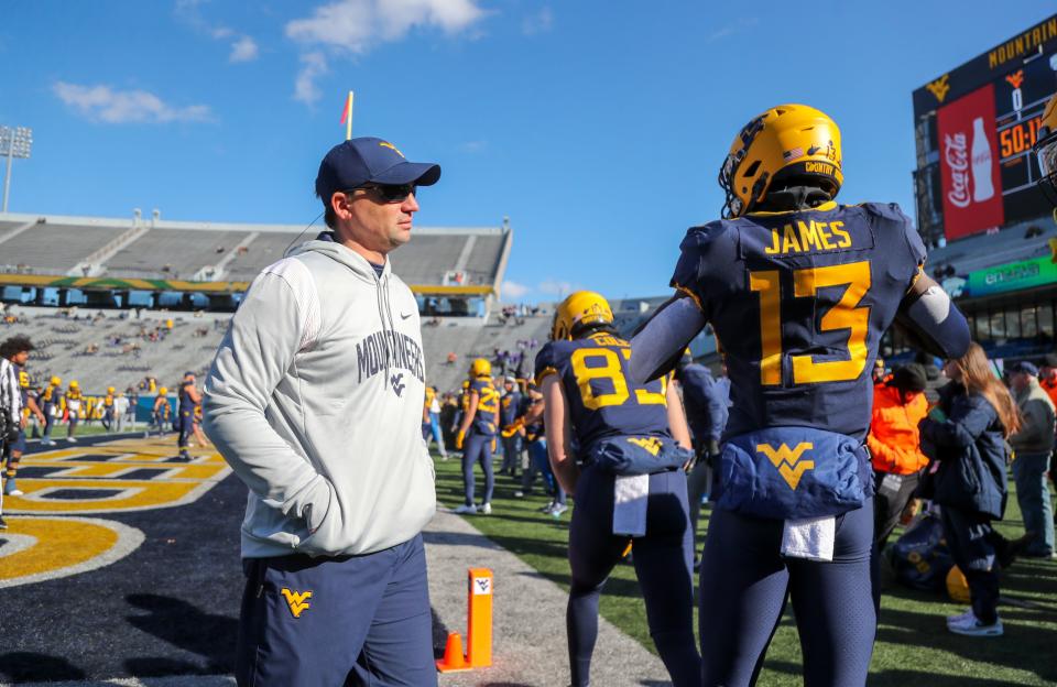 Nov 19, 2022; Morgantown, West Virginia, USA; West Virginia Mountaineers head coach Neal Brown talks with West Virginia Mountaineers wide receiver Sam James (13) during warmups prior to their game against the Kansas State Wildcats at Mountaineer Field at Milan Puskar Stadium. Mandatory Credit: Ben Queen-USA TODAY Sports