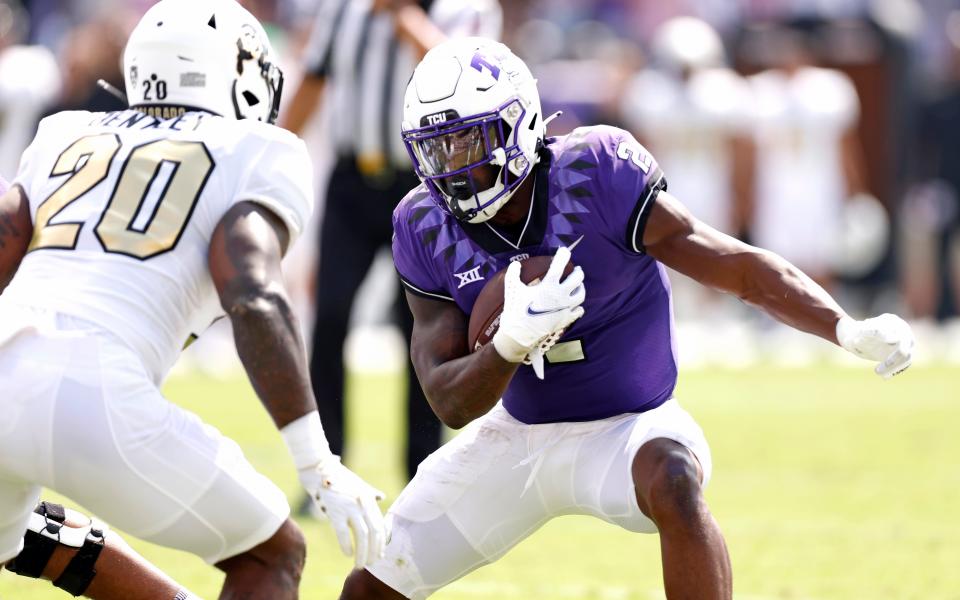 FORT WORTH, TX - SEPTEMBER 2: Trey Sanders #2 of the TCU Horned Frogs eludes LaVonta Bentley #20 of the Colorado Buffaloes during the first half at Amon G. Carter Stadium on September 2, 2023 in Fort Worth, Texas. (Photo by Ron Jenkins/Getty Images)