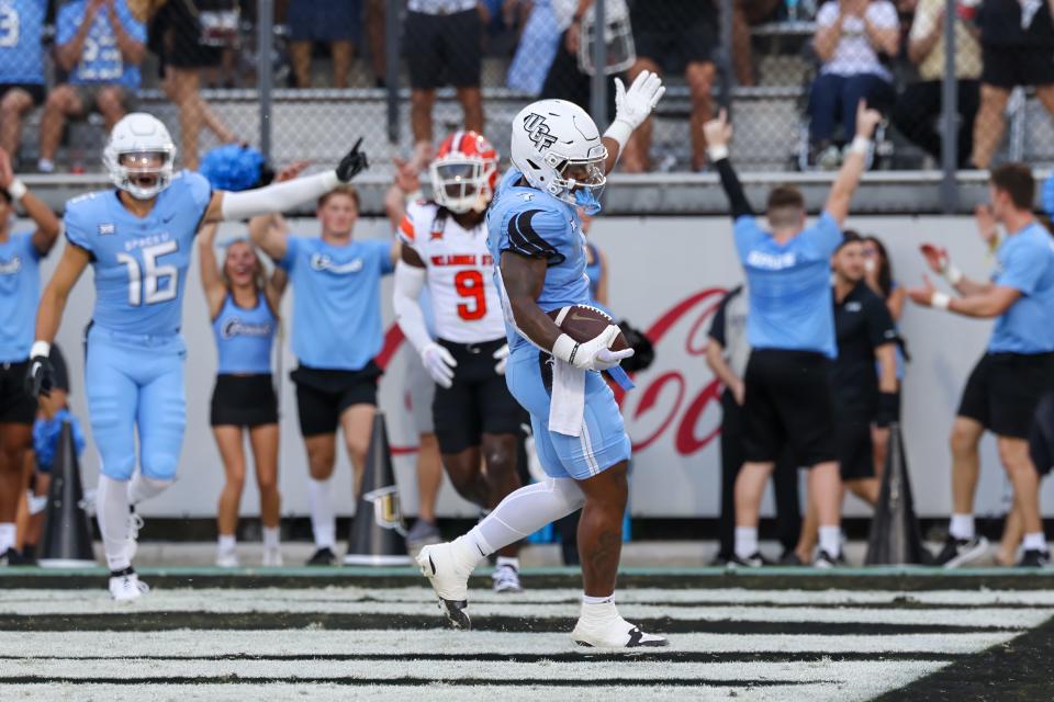 Nov 11, 2023; Orlando, Florida, USA; UCF Knights running back RJ Harvey (7) celebrates after scoring a touchdown during the first quarter against the Oklahoma State Cowboys at FBC Mortgage Stadium. Mandatory Credit: Mike Watters-USA TODAY Sports