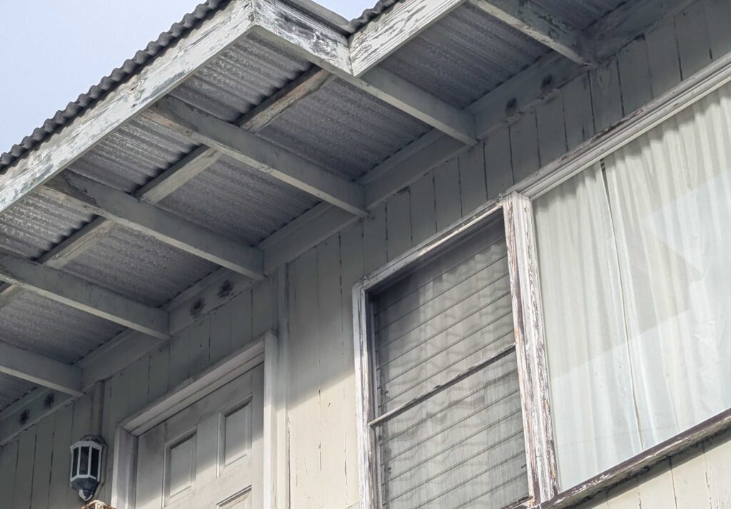 A picture of a house, looking at the underside of the roof, which shows two circular holes that promote airflow and prevent moisture accumulation.They are required by most building codes. But if left uncovered, they can suck in embers during wildfires, starting fires in the roof space. (Thomas Heaton/Civil Beat/2024) 