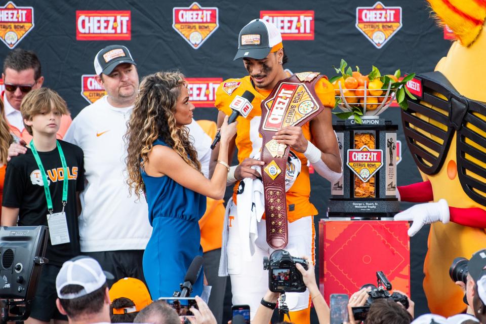 Jan 1, 2024; Orlando, FL, USA; Tennessee Volunteers quarterback Nico Iamaleava (8) receives the Cheez-It’s MVP award for the win over the Iowa Hawkeyes at Camping World Stadium. Mandatory Credit: Jeremy Reper-USA TODAY Sports