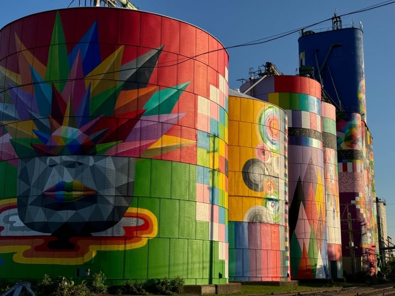 Colourful murals on an abandoned silo structure.