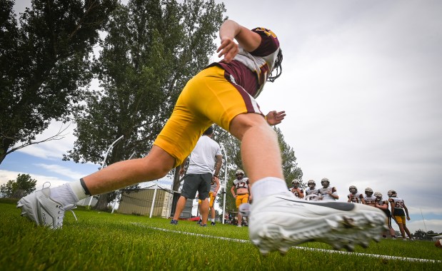 The Windsor High School football team goes through drills during a practice on Wednesday Aug. 21, 2024 in Windsor. The team raised money to buy practice jerseys for a football team in North Carolina that features many players from underserved populations.(Jim Rydbom/Staff Photographer)