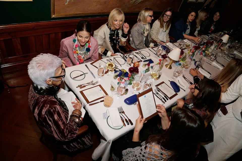 Iris Apfel sitting at a dinner with guests at The Polo Bar in April  2017 in New York City.