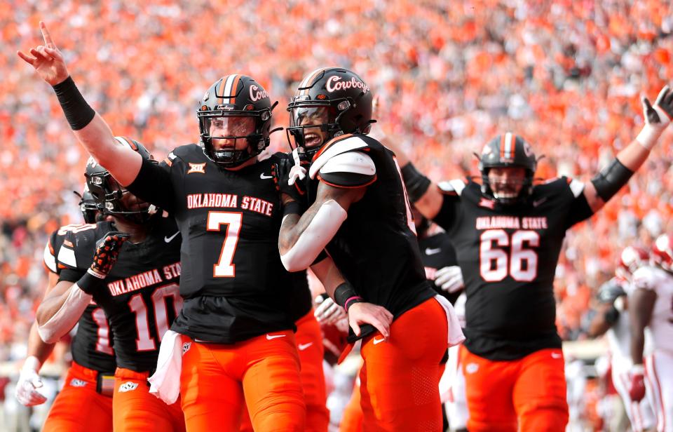 Oklahoma State's Alan Bowman (7) celebrates his touchdown with Ollie Gordon II (0) in the first half during a Bedlam college football game between the Oklahoma State University Cowboys (OSU) and the University of Oklahoma Sooners (OU) at Boone Pickens Stadium in Stillwater, Okla., Saturday, Nov. 4, 2023.