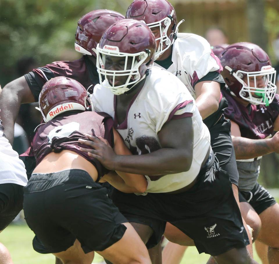 OL Jakobe Green makes a block during a Niceville Eagles football practice.