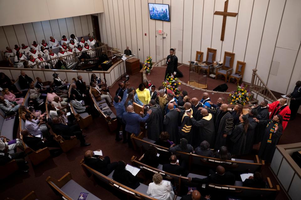 Family and church members perform the laying on of hands during installation services of the Rev. Shane B. Scott at First Baptist Church, Capitol Hill in Nashville, Tenn., Saturday, June 1, 2024.