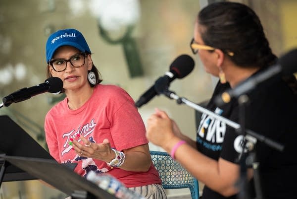 A woman talks into a microphone