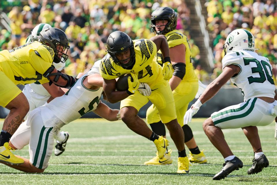 Sep 2, 2023; Eugene, Oregon, USA; Oregon Ducks running back Dante Dowdell (24) breaks a tackle to pick up a first down during the second half against the Portland State Vikings at Autzen Stadium. Mandatory Credit: Troy Wayrynen-USA TODAY Sports