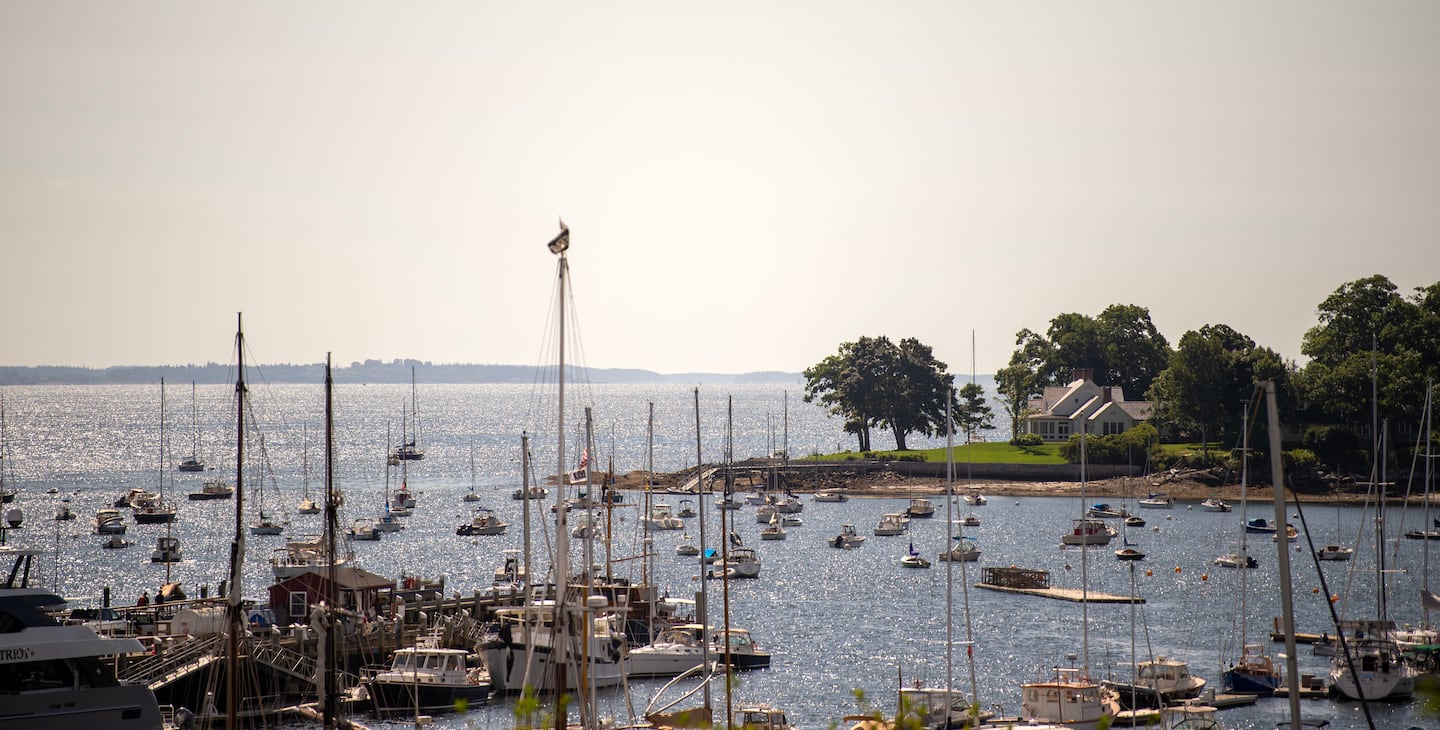 Boats fill Sherman Cove with Laite Memorial Beach to the far right of the home on Dillingham Point in Camden, Maine on Thursday, August 22, 2024.