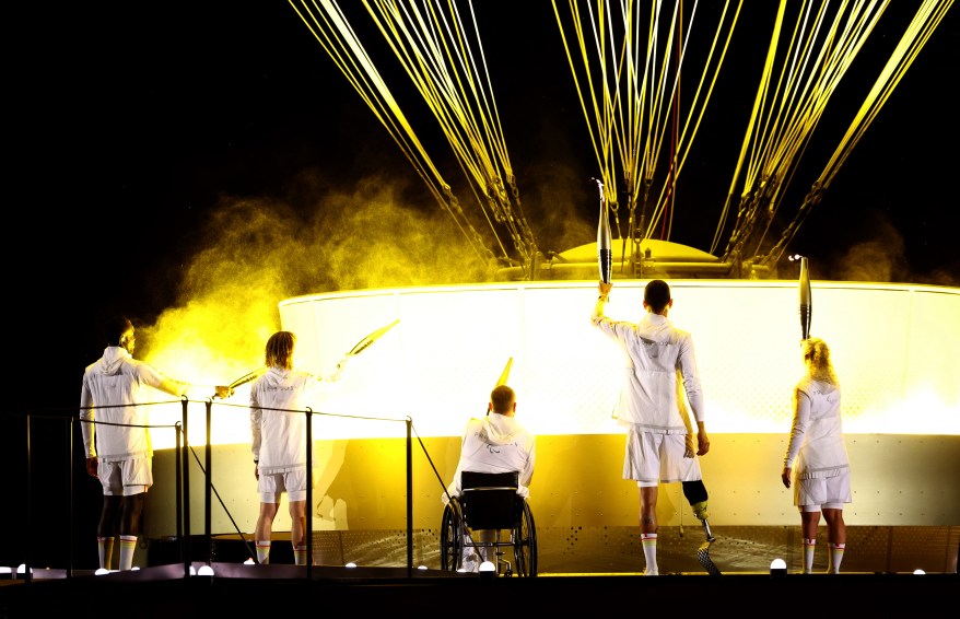 Charles-Antoine Kouakou, Nantenin Keita, Fabien Lamirault, Alexis Hanquinquant and Elodie Lorandi lit The Olympic cauldron.