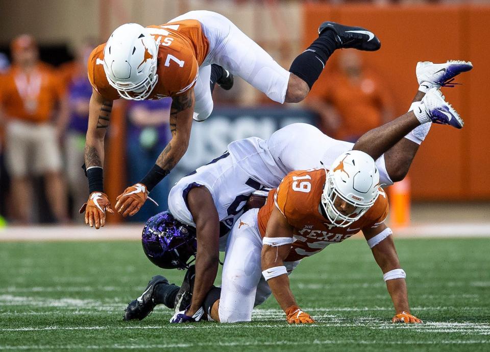 Texas defensive back Brandon Jones (19) teams up with defensive back Caden Sterns (7) to tackle TCU wide receiver Jarrison Stewart (22) during an NCAA college football game in Austin, Texas, on Saturday, Sept. 22, 2018.