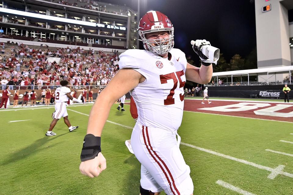 STARKVILLE, MISSISSIPPI - SEPTEMBER 30: Wilkin Formby #75 of the Alabama Crimson Tide waves a Mississippi State Bulldogs cowbell after the game at Davis Wade Stadium on September 30, 2023 in Starkville, Mississippi. (Photo by Justin Ford/Getty Images)