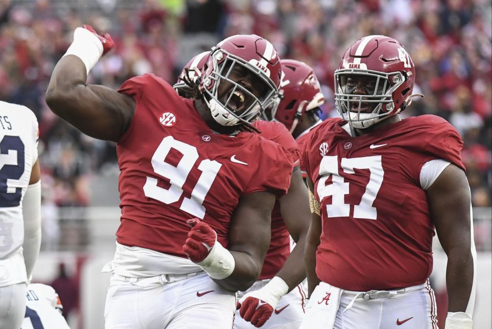 Nov 26, 2022; Tuscaloosa, Alabama, USA; Alabama Crimson Tide defensive lineman Jaheim Oatis (91) celebrates after tackling Auburn Tigers quarterback Robby Ashford (9) at Bryant-Denny Stadium. Alabama won 49-27. Mandatory Credit: Gary Cosby Jr.-USA TODAY Sports