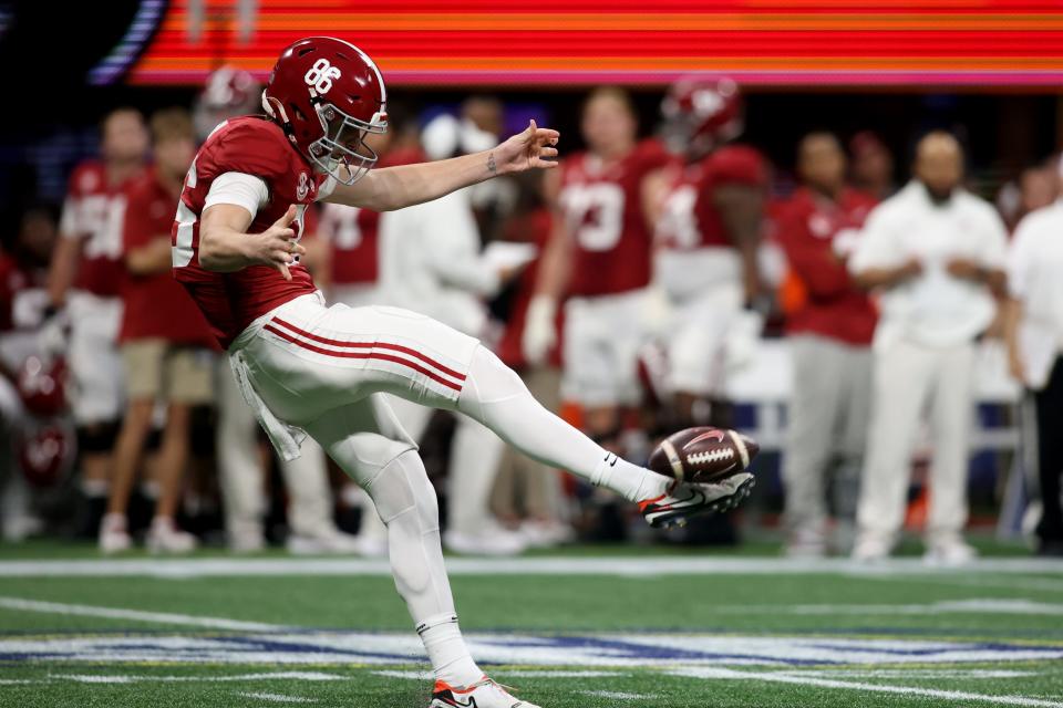 Dec 2, 2023; Atlanta, GA, USA; Alabama Crimson Tide punter James Burnip (86) punts against the Georgia Bulldogs in the first quarter at Mercedes-Benz Stadium. Mandatory Credit: Brett Davis-USA TODAY Sports