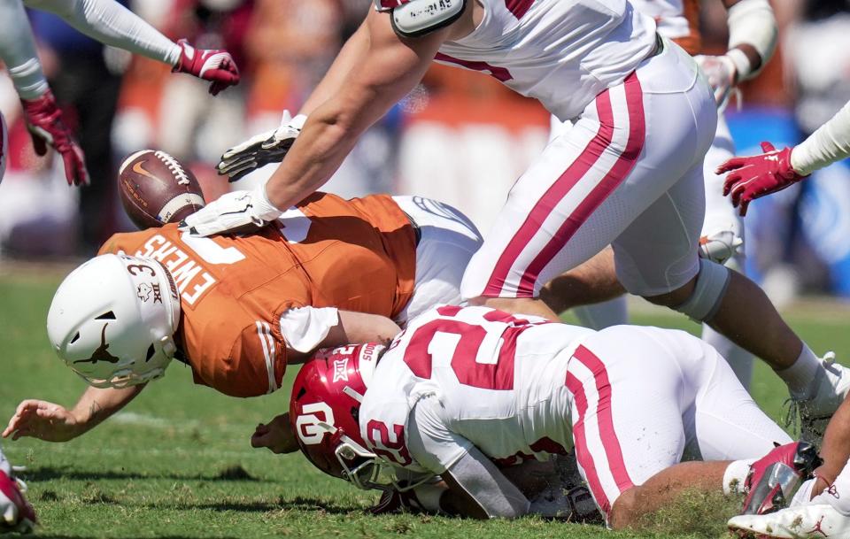 Texas Longhorns quarterback Quinn Ewers (3) fumbles the ball in the third quarter against Oklahoma Sooners defensive lineman Ethan Downs - Ricardo B. Brazziell/American-Statesman / USA TODAY NETWORK