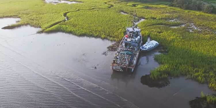 A video screen grab shows two vessels, one of which is a 120-foot-long former Navy mine sweeper, parked on Bohicket Creek, S.C.