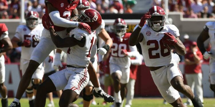 Apr 13, 2024; Tuscaloosa, AL, USA; Alabama running back Jam Miller (26) runs the ball behind a block by Alabama wide receiver Kendrick Law (19) on Alabama defensive back Keon Sabb (3) during the A-Day scrimmage at Bryant-Denny Stadium. Mandatory Credit: Gary Cosby Jr.-USA TODAY Sports