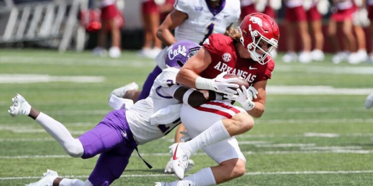 Sep 2, 2023; Little Rock, Arkansas, USA; Arkansas Razorbacks tight end Luke Hasz (9) catches a pass in the first quarter as Western Carolina Catamounts safety Andreas Keaton (21) makes a tackle at War Memorial Stadium. Mandatory Credit: Nelson Chenault-USA TODAY Sports