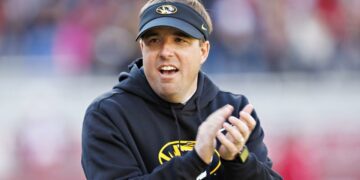 FAYETTEVILLE, ARKANSAS - NOVEMBER 24: Head Coach Eli Drinkwitz of the Missouri Tigers watches his team warm up before the game against the Arkansas Razorbacks at Donald W. Reynolds Razorback Stadium on November 24, 2023 in Fayetteville, Arkansas. (Photo by Wesley Hitt/Getty Images)