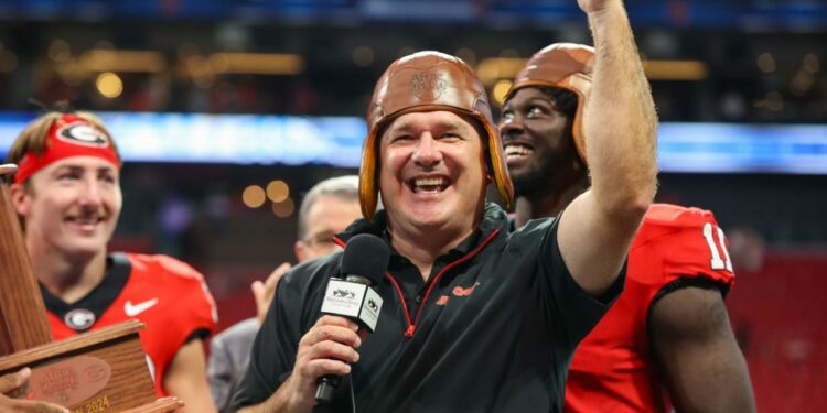 Georgia coach Kirby Smart wears the old leather helmet after the Bulldogs' victory over Clemson at Mercedes-Benz Stadium in Atlanta on Aug. 31, 2024.