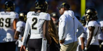 Oct 7, 2023; Tempe, Arizona, USA; Colorado Buffaloes head coach Deion Sanders with son and quarterback Shedeur Sanders (2) against the Arizona State Sun Devils at Mountain America Stadium. Mandatory Credit: Mark J. Rebilas-USA TODAY Sports